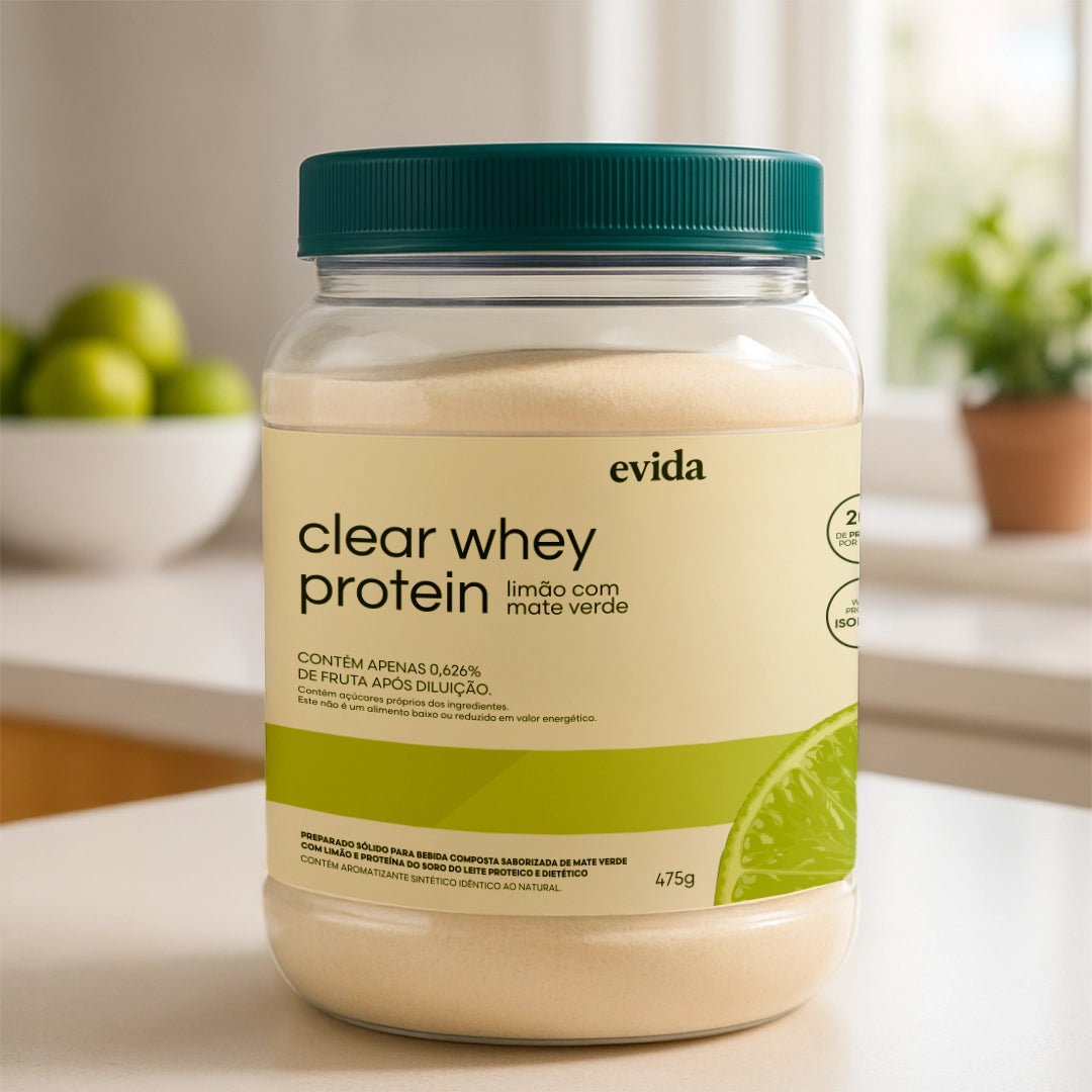 Clear whey protein powder container with lime and green tea flavor on a kitchen countertop